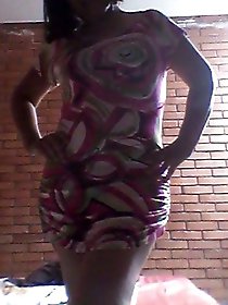 Older woman posing for a photoshoot with her legs opened in a suggestive manner.