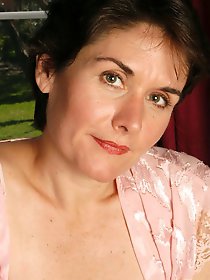 An elderly whore is posing without clothes on the camera