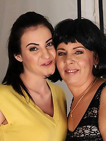 Horny old and young lesbian couple making out on the couch