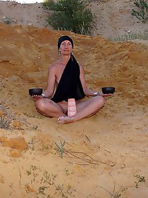 On sand seminude with light-color vase