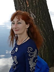 A beautiful mature woman is fondling her genital area